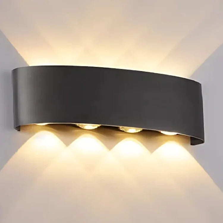 Modern black wall sconce with warm LED lighting, ideal for contemporary interior decor and ambient illumination.