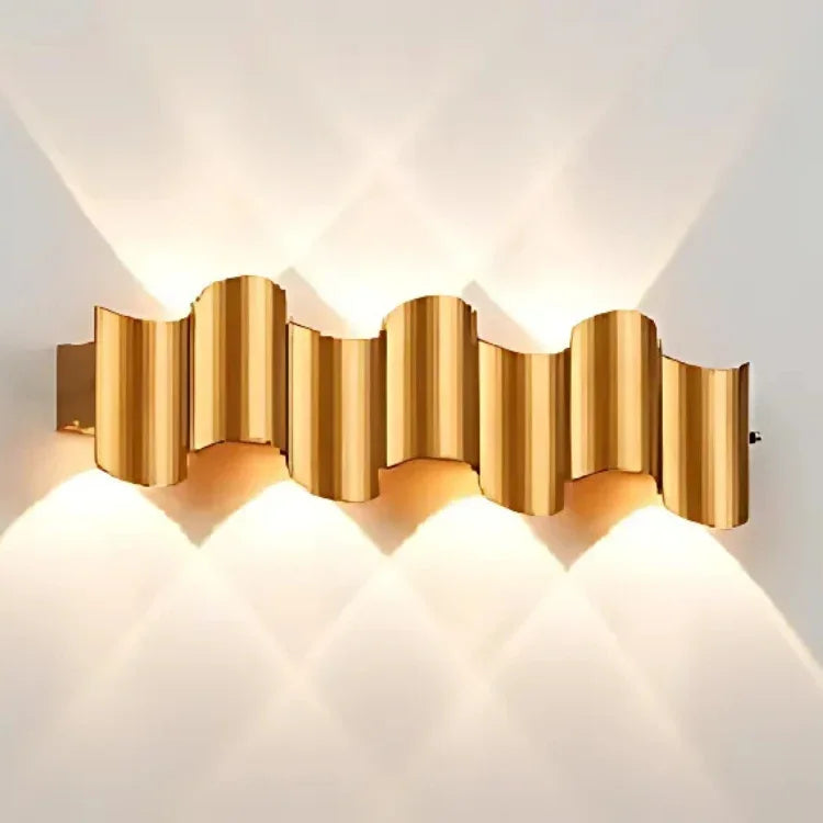 Modern gold wave wall sconce with warm ambient lighting for contemporary interior decor